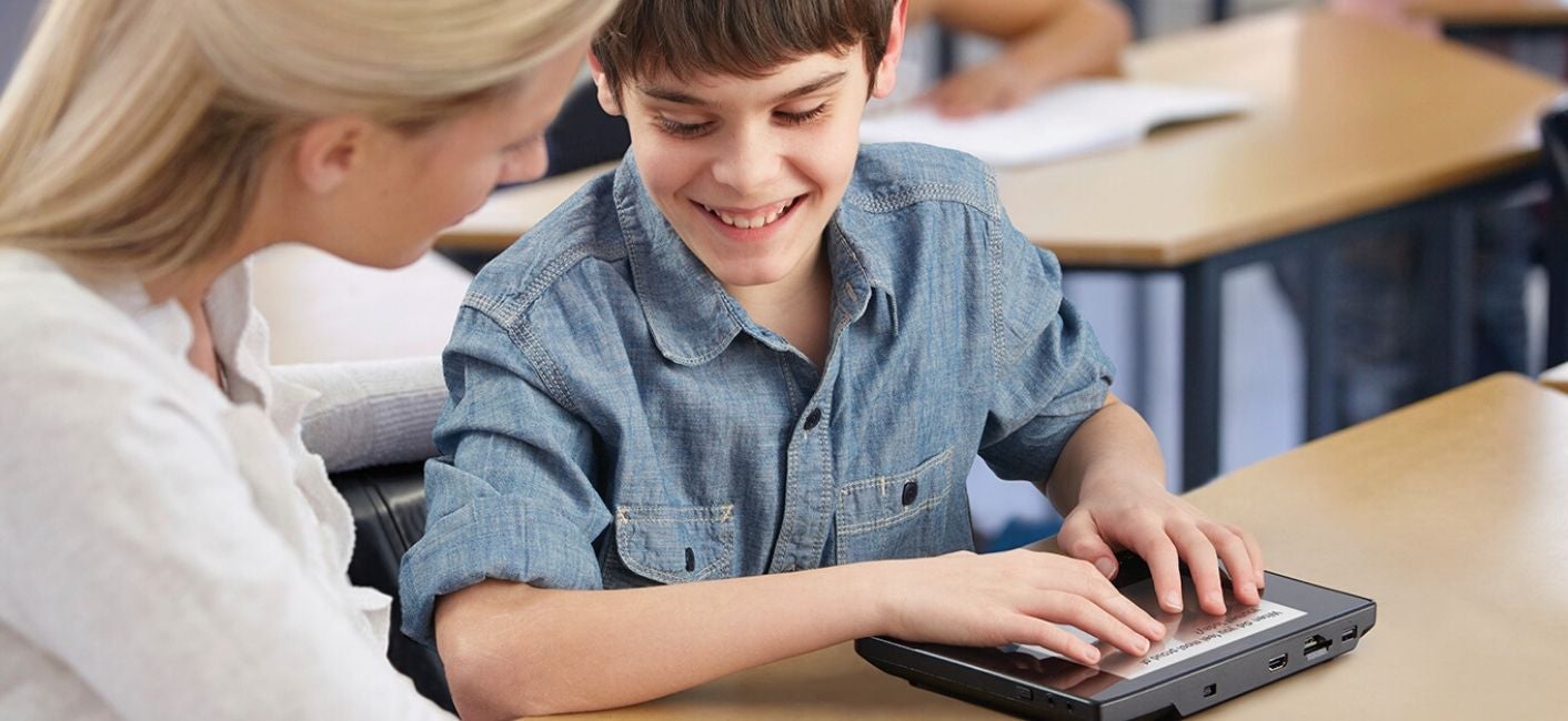 This image shows a student using braille keyboard