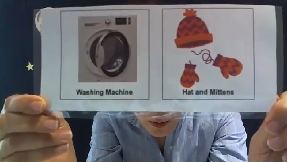 Instructor showing an image of washing machine and mittens to the participants. 